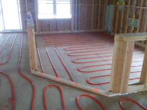 An example of a radiant floor heating set up. The heating tubes are put down on floor and gypsum is then poured on top.